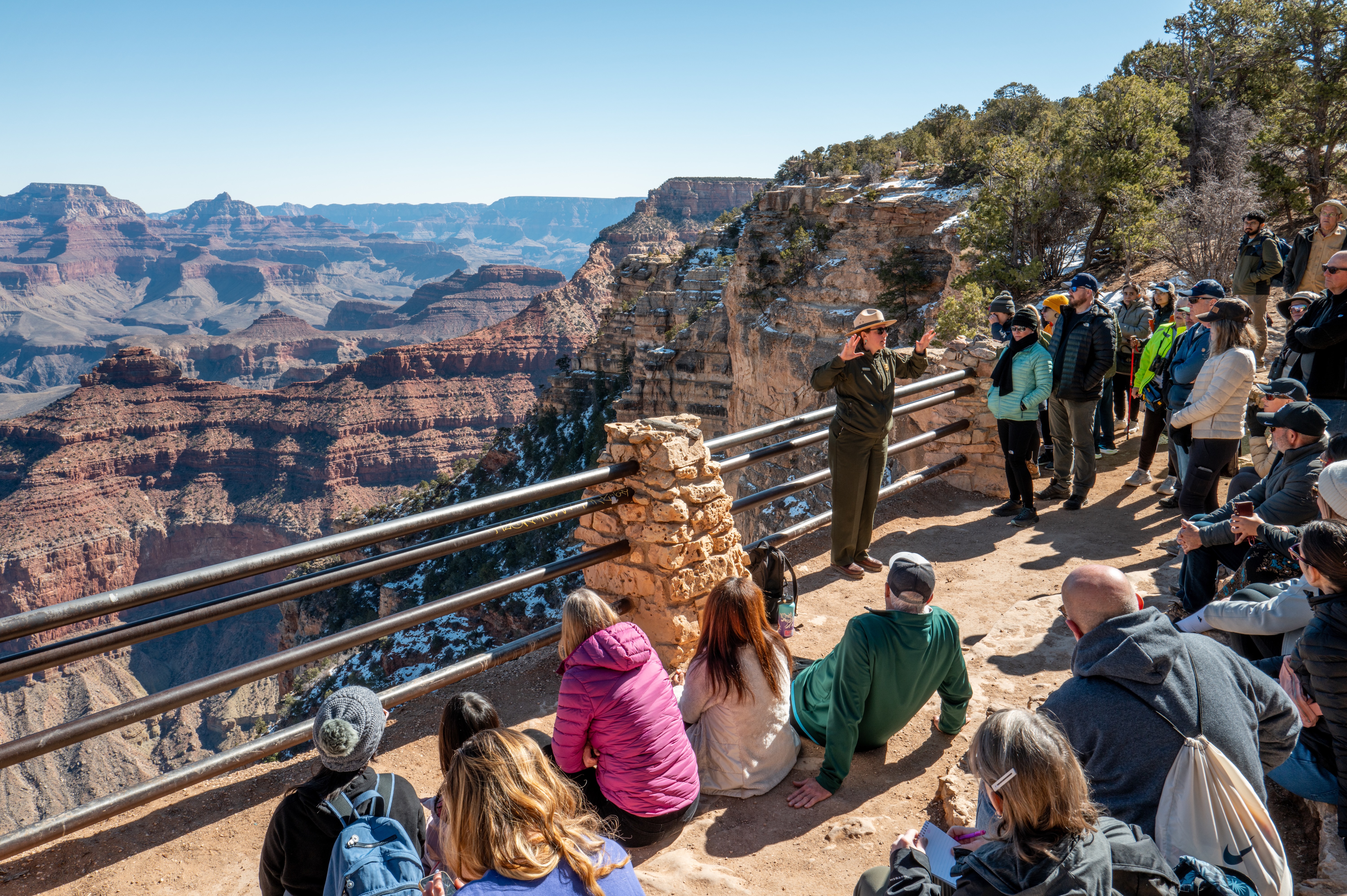 A park ranger discusses the Grand Canyon with tourists at the South Rim
