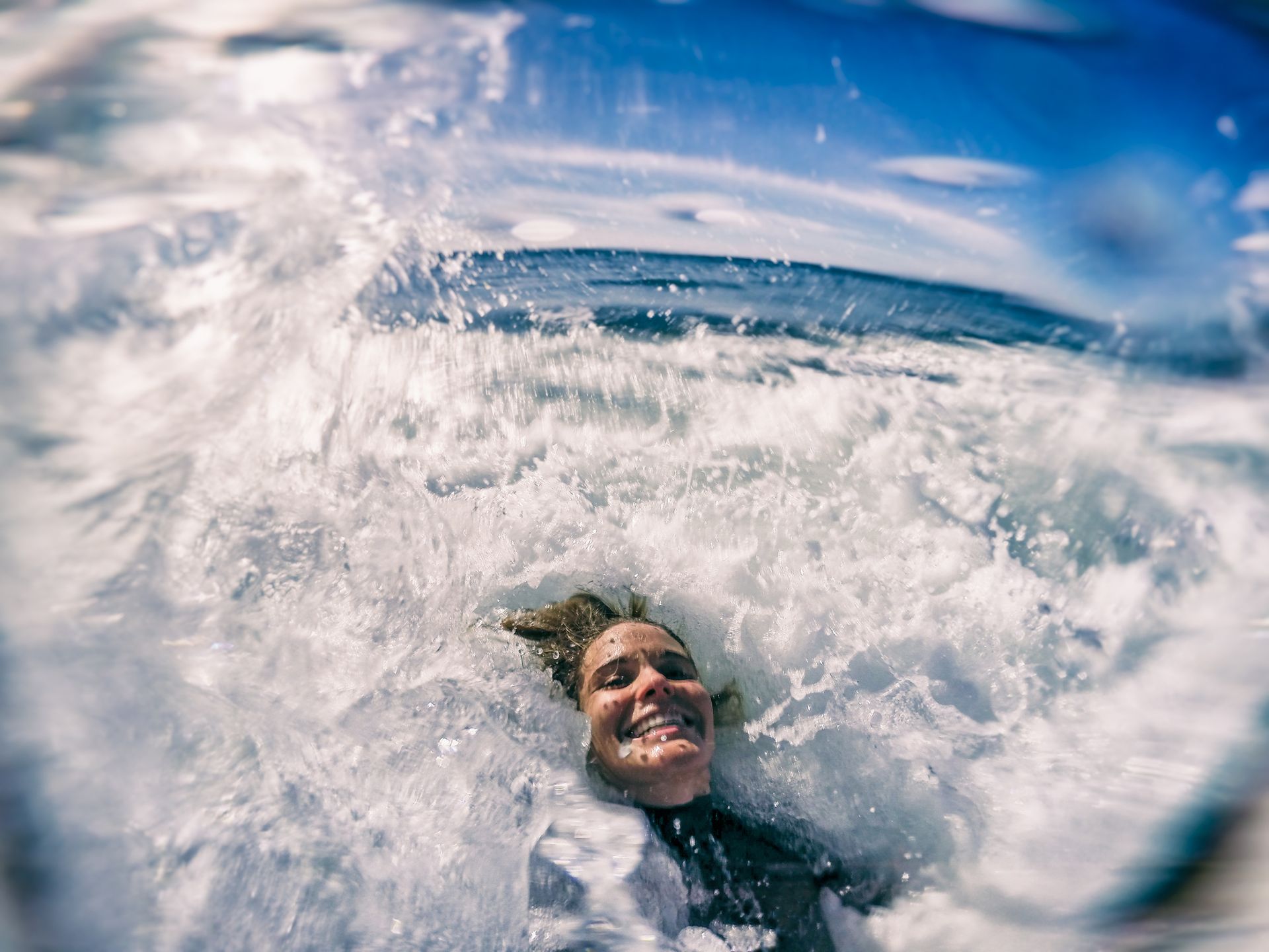 IS cold water bad for you? A woman takes a photo in the sea