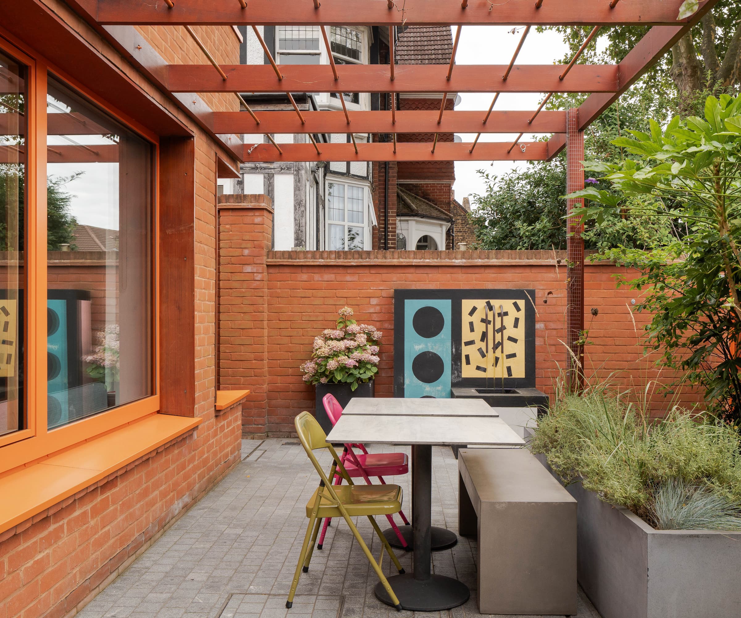 A terrace of a red brick house and potted plants