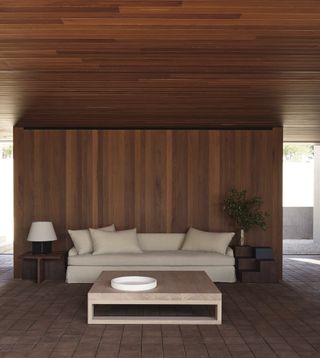 Cream sofa in wooden paneled room