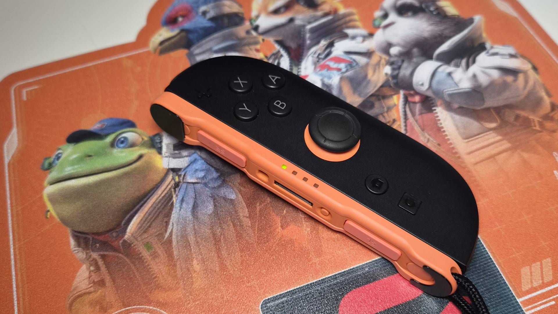 Photo of a Switch 2 Joy-Con sitting on the Star Fox mousepad.
