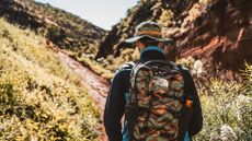 best hiking backpacks: hiker wearing the full The North Face Summer Exploration Collection
