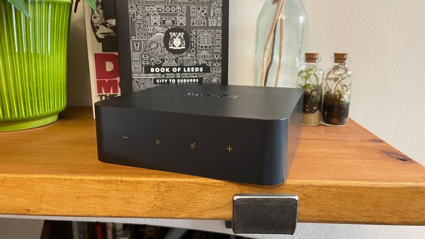 WiiM Pro Plus black streamer on wooden shelf