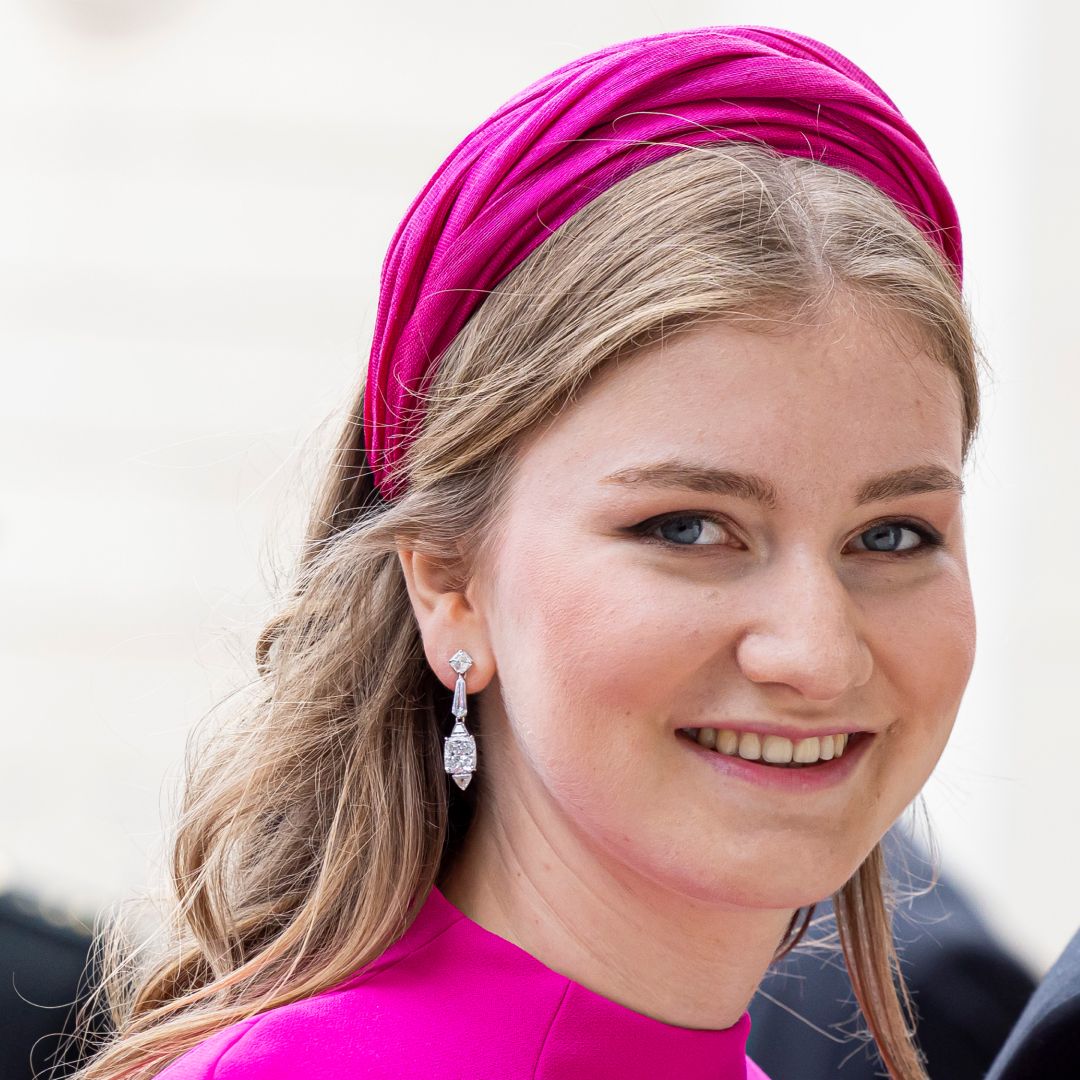 Princess Elisabeth of Belgium smiling in a pink dress and headband