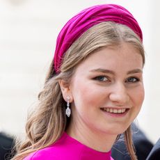 Princess Elisabeth of Belgium smiling in a pink dress and headband