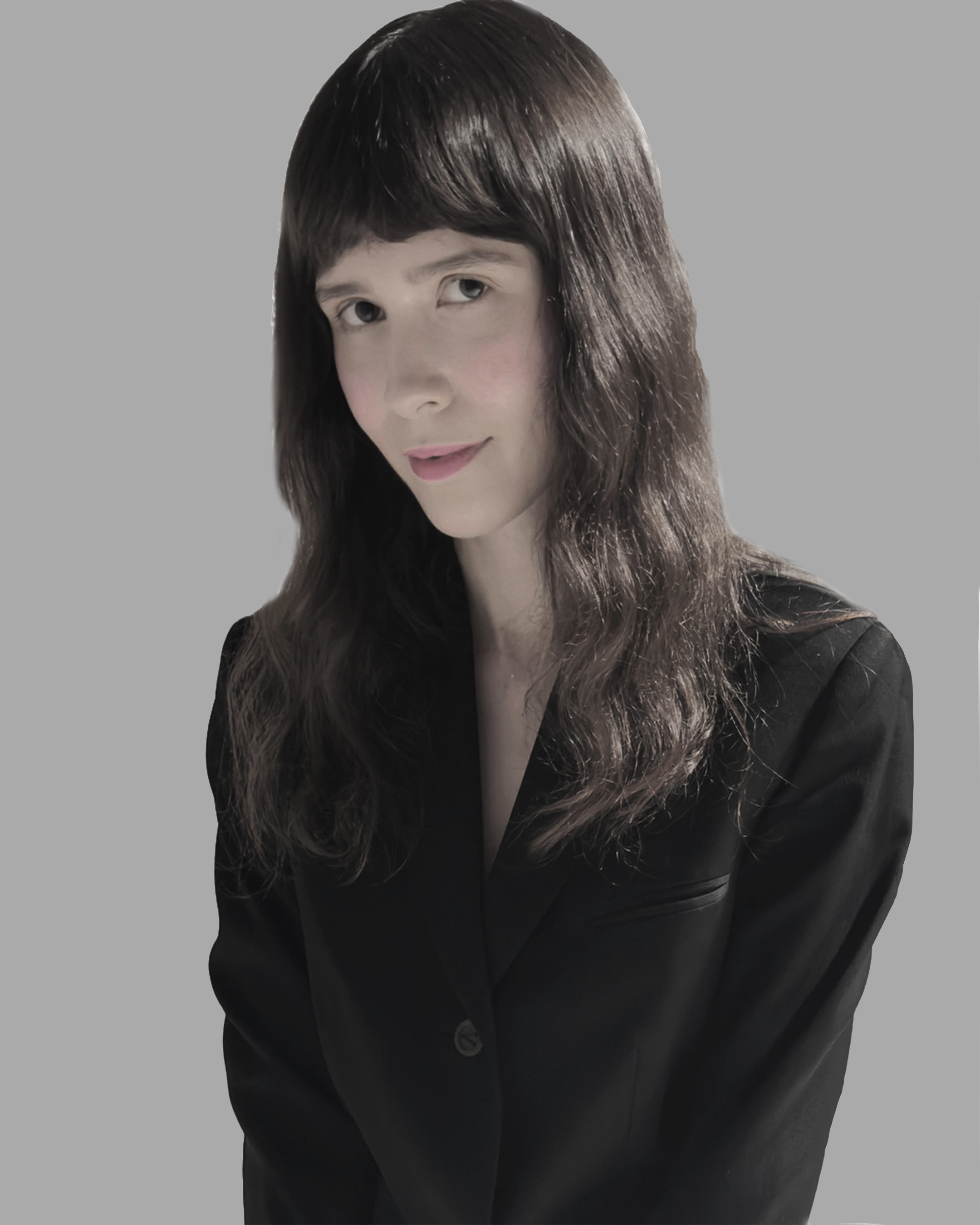 Rebekah Sherman-Myntti in a dark blazer, smiling against a gray background.