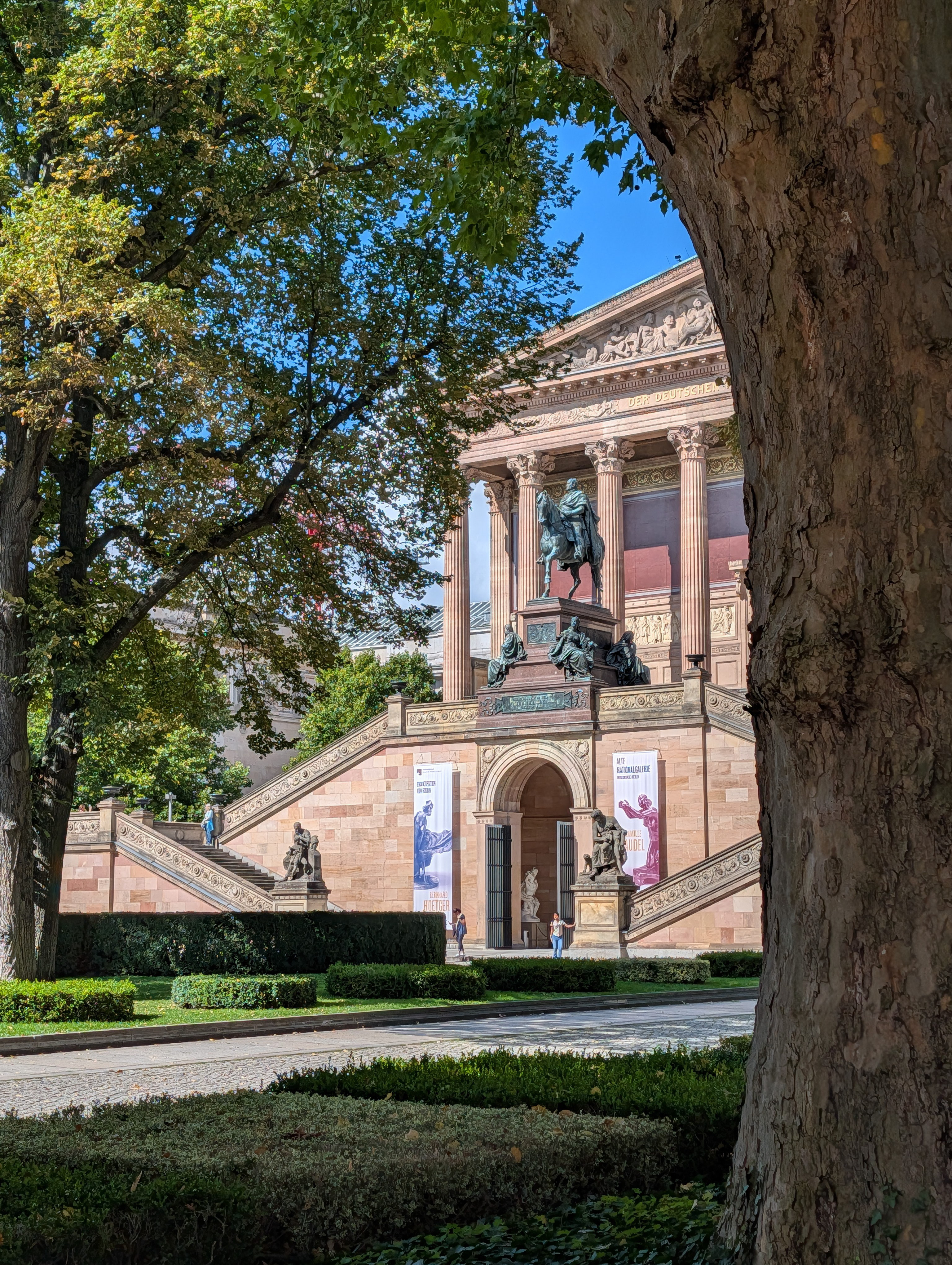 View of a gallery in Berlin through a gap in some trees