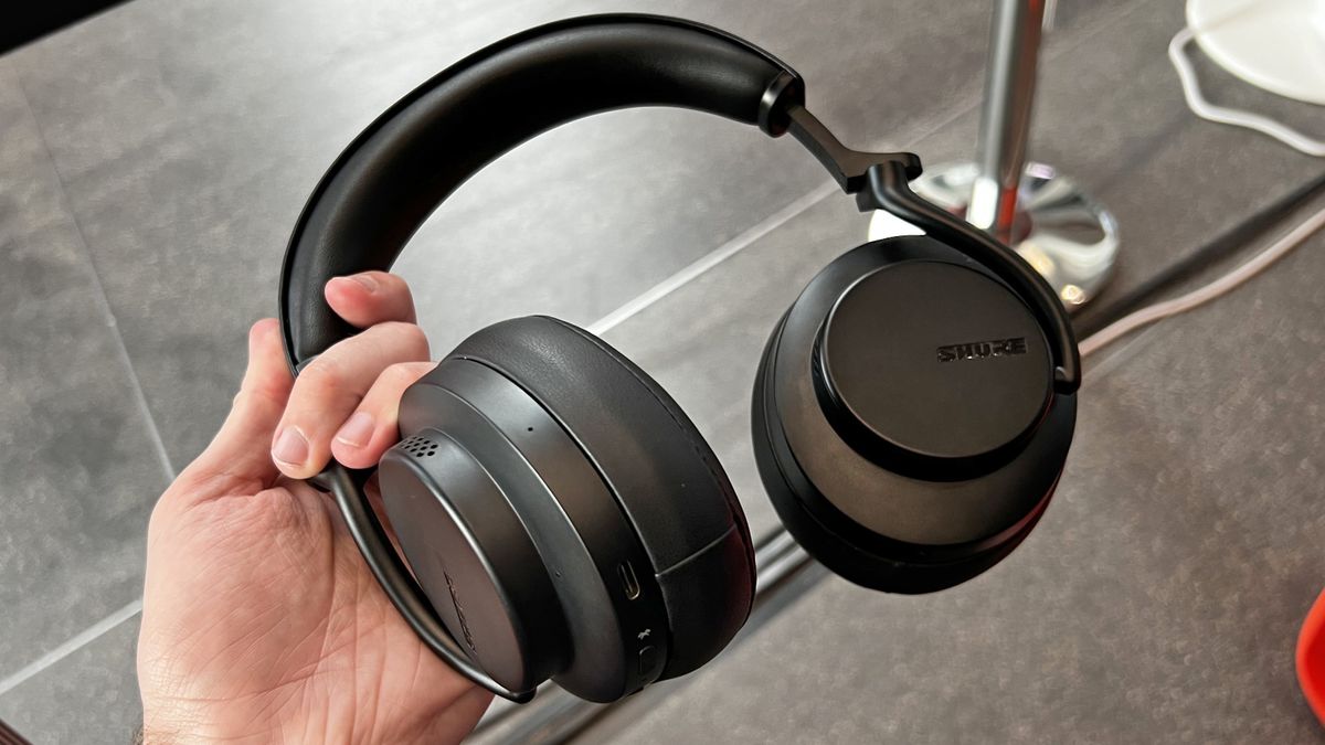 Shure AONIC 50 Gen 2 headphones held in a man&#039;s hand