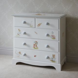 light grey wall with design print on drawers
