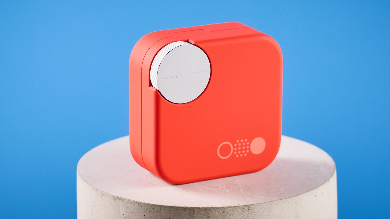 the nothing cmf buds pro 2 cmf by nothing buds pro 2 in bright orange shown in the smart dial charging case against a blue tom's guide background