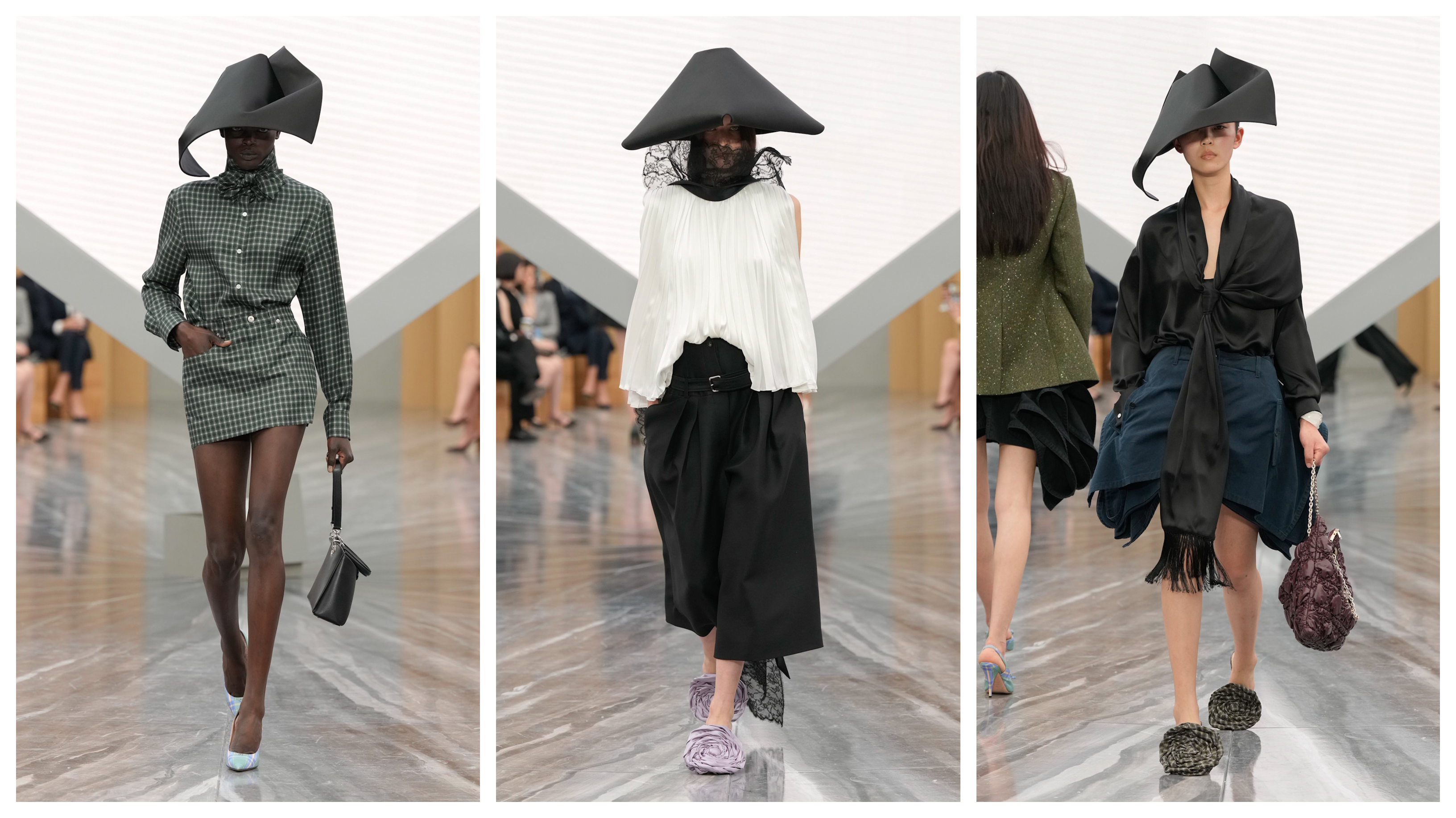 three models at the Dior womenswear show wearing large hats