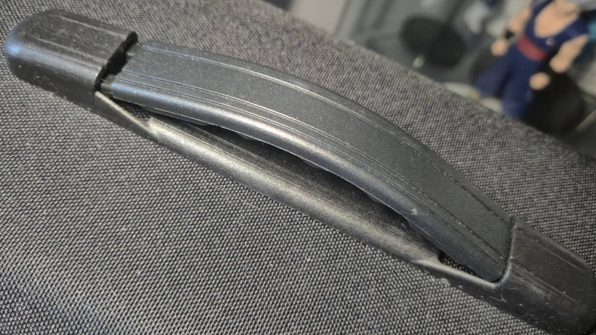 Close up photo of the black, plastic JSAUX carrying case handle.