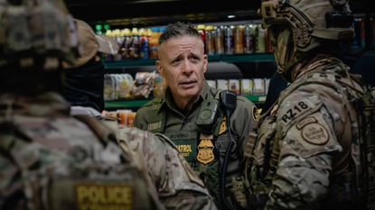 Gregory Bovino talks with other Border Patrol agents in a Chicago gas station.