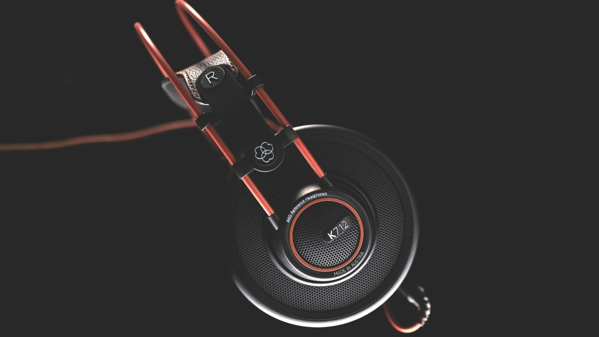 A pair of AKG K712 studio headphones on a black background