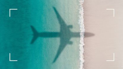 Aerial shot showing an aircraft shadow flying over an idyllic beach scene, Barbados