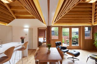 Inside a light-filled bungalow with midcentury furniture and dual vaulted ceilings