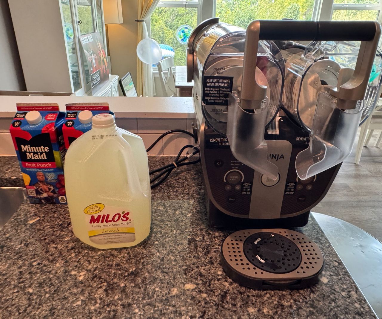 A Ninja Slushi Twist on a kitchen counter beside a jug of lemonade