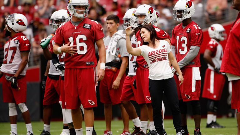 NFL Female Coach on field with players