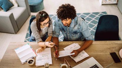 Couple pictured from above are looking at accounts