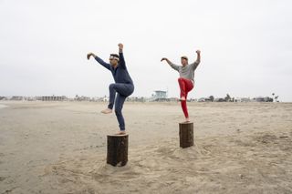 two men train for karate on poles on the beach in cobra kai season 6 part 3