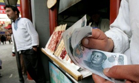 A man with Chinese Yuan at Beijing food stall