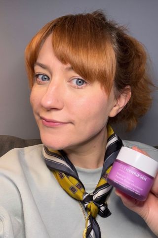 a headshot of Matilda with a tub of ole henriksen strength trainer peptide moisturizer