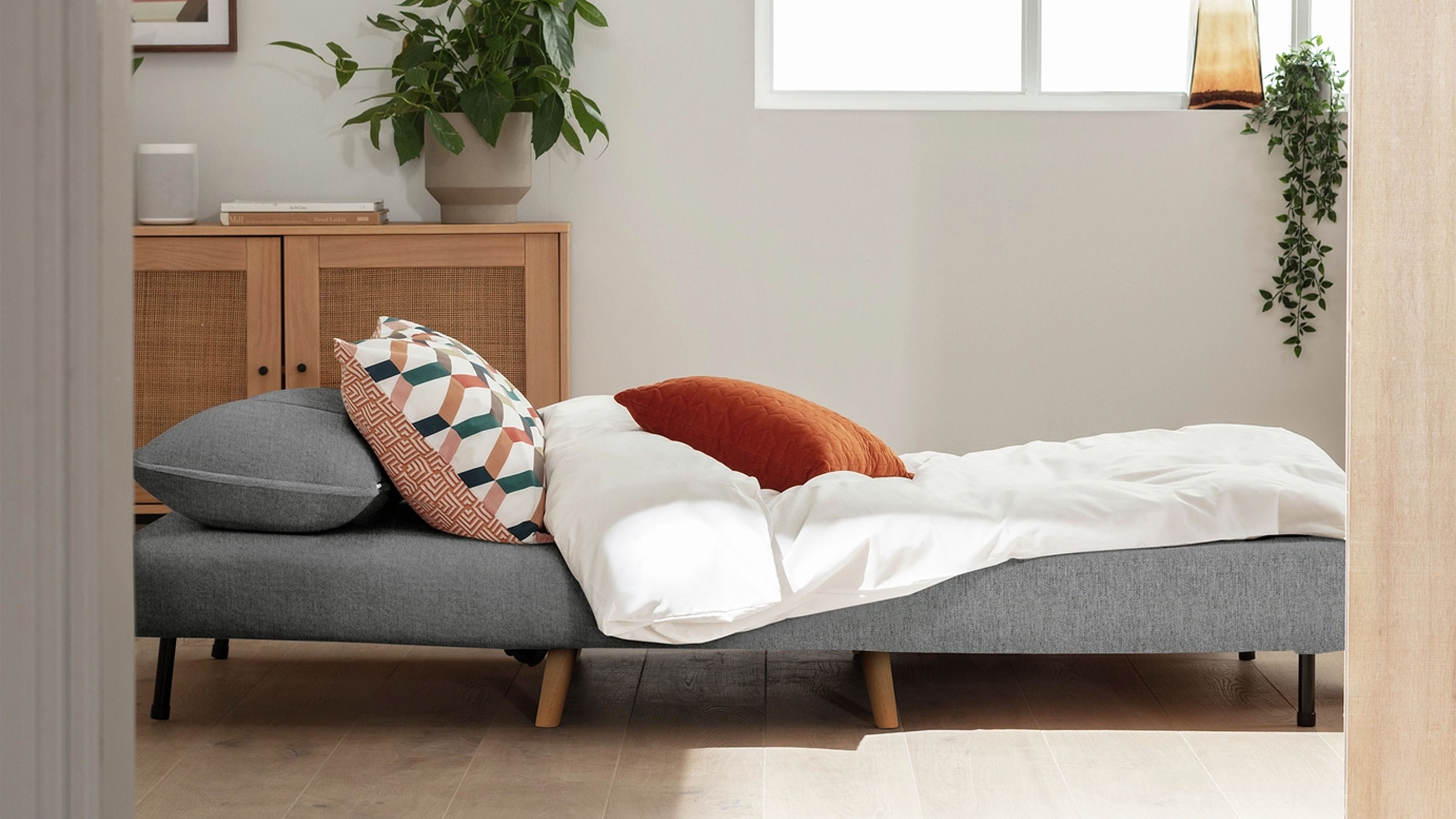 Habitat Roma Chair Bed in gery in a room with a wooden floor