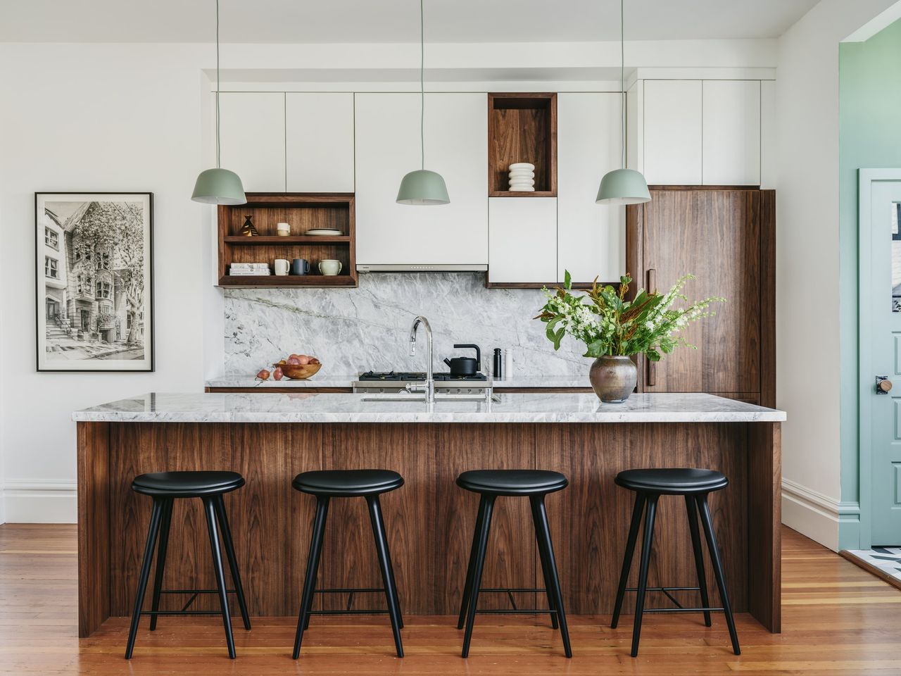 kitchen island centerpiece ideas; white kitchen with wood kitchen island and marble backsplash by Banner Day Interiors