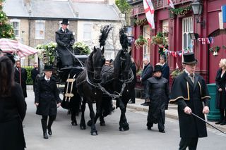 Dot's funeral- black horses and carriage carrying Dot Cotton's coffin outside The Vic