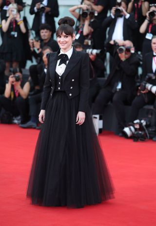 Winona Ryder wears a black gown on the red carpet at the 2024 Venice Film Festival