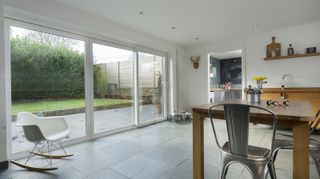White patio sliding doors from modern kitchen diner area