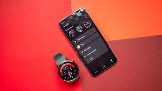 OnePlus Watch 2 next to phone showing settings