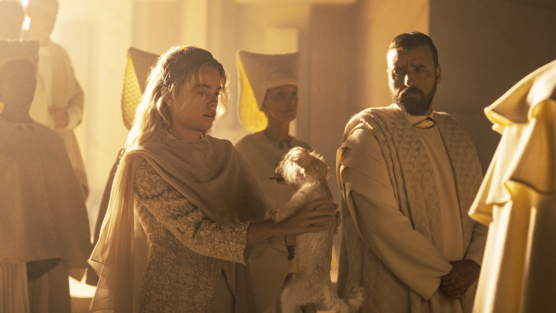 Kara Zor-El holding Krypto as a puppy while her father looks on in Supergirl