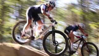 Blurred mountain bikers racing