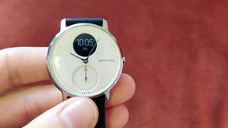 Withings Steel HR smartwatch against red background