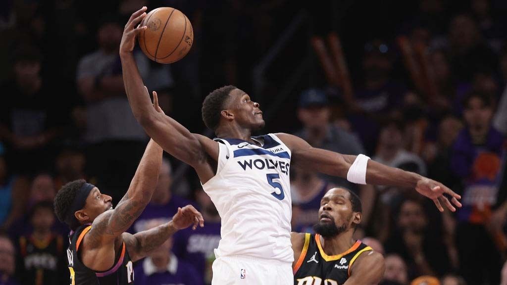 Anthony Edwards #5 of the Minnesota Timberwolves slam dunks the ball ahead of Bradley Beal #3 and Kevin Durant #35 of the Phoenix Suns during the second half of game four of the Western Conference First Round Playoffs at Footprint Center on April 28, 2024 