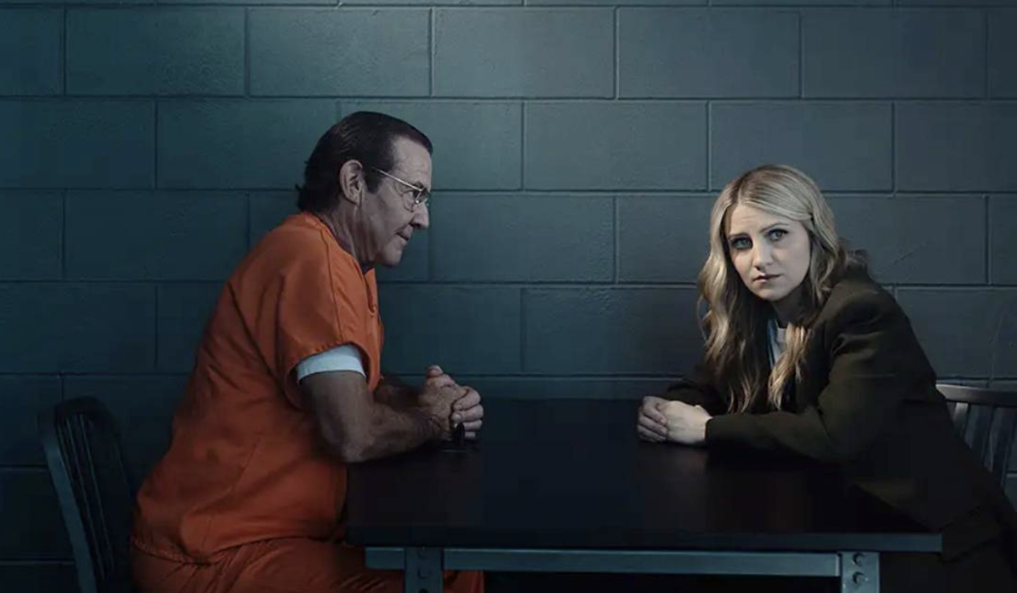 Dennis Quaid and Annaleigh Ashford sit opposite each other in an interrogation room in Happy Face