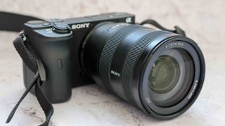Sony E 16-55mm f/2.8 G Lens attached to a Sony A6600 with a marble background