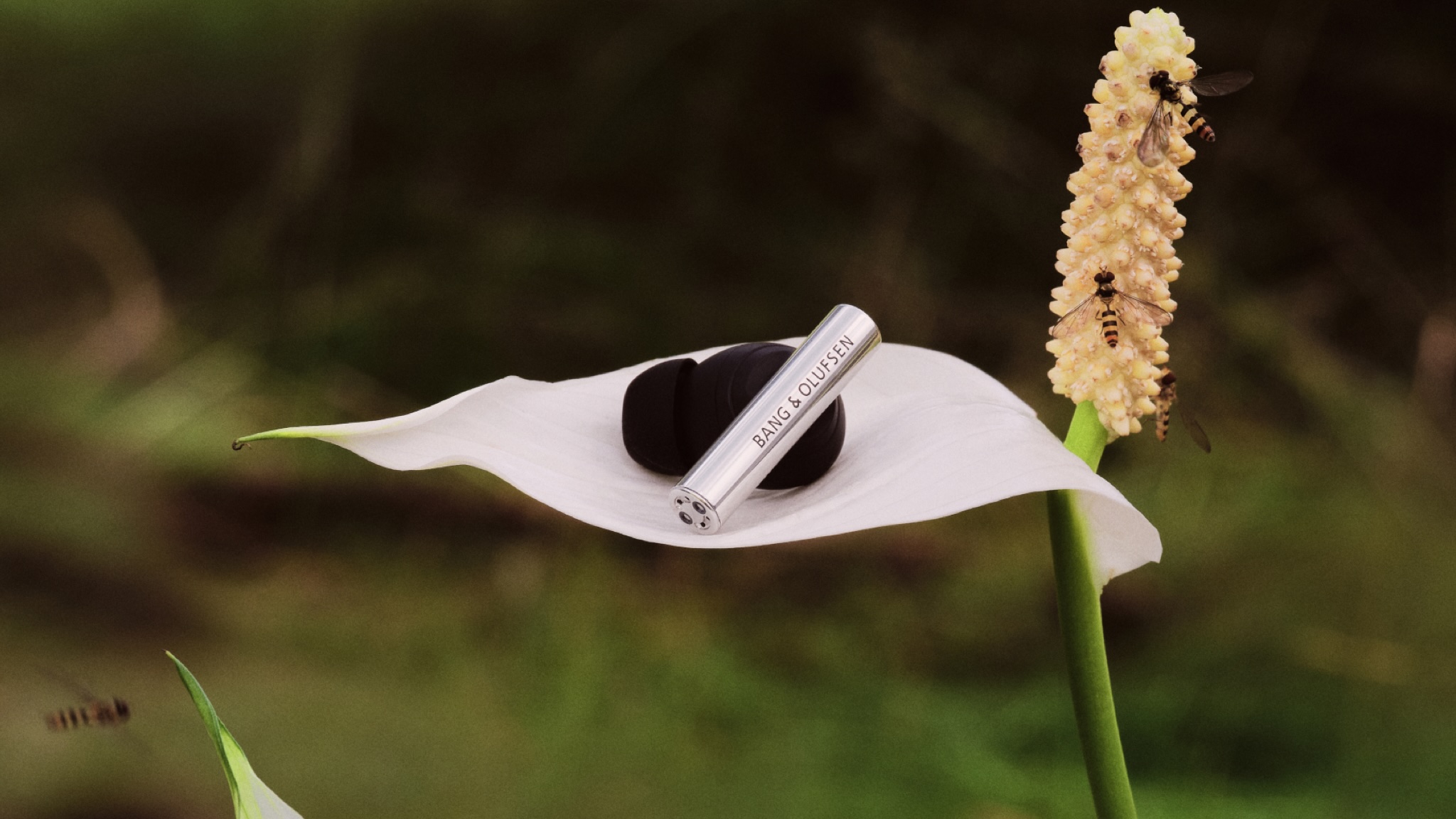 Bang &amp;amp; Olufsen Beo Grace earbud on a white leaf