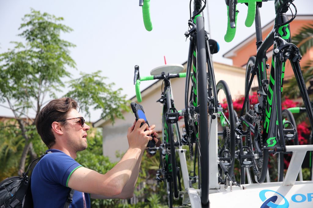 That's not a fan taking a photo of team bikes, it's one of the many bike checks the UCI has carried out for motors