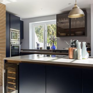navy blue kitchen island with compact wine fridge