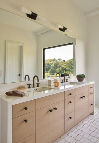 White bathroom with wooden cabinetry