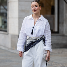 BERLIN, GERMANY - MARCH 24: Tina Haase wears white linen shirt, white barrel pants Meshki, striped scarf, tassel necklace Nakd, vintage Silver clutch bag on March 24, 2026 in Berlin, Germany. (Photo by Christian Vierig/Getty Images)