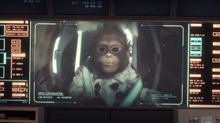 a screen with flight information on the sides shows the image of a young chimpanzee puppet in a space suit in a space capsule.