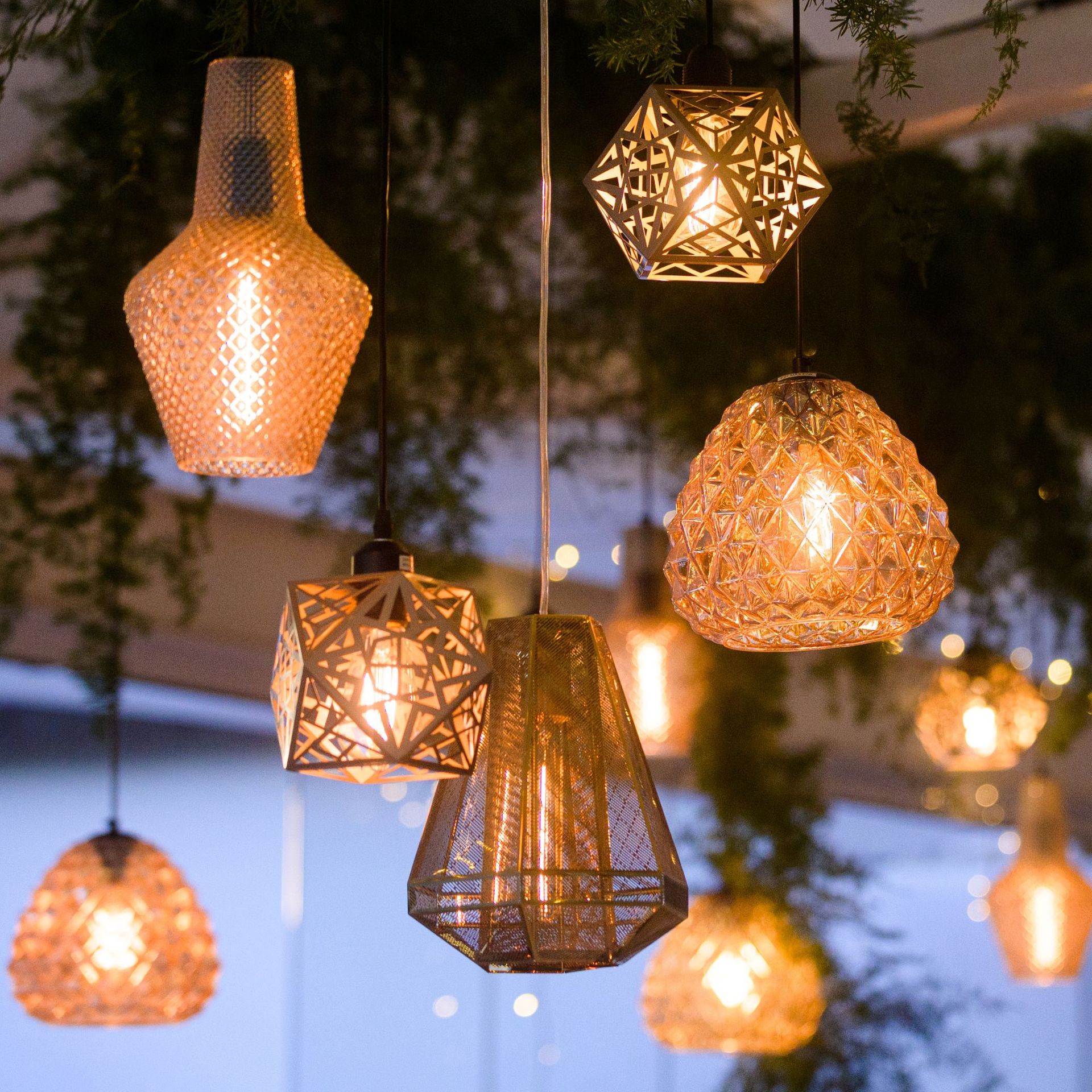 Various golden shining illuminated lounge lights hanging together