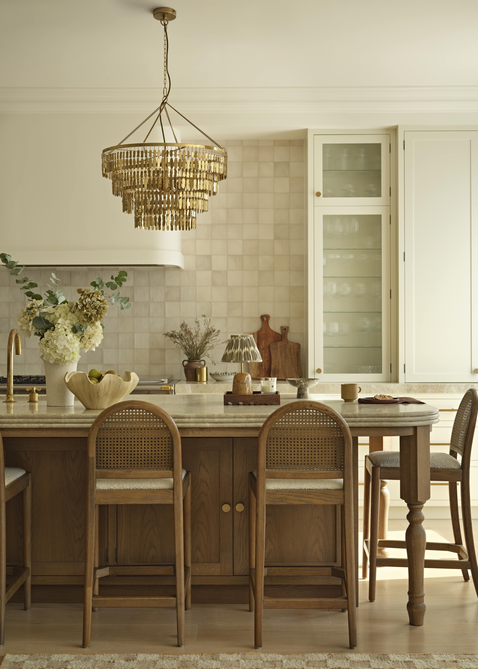white kitchen with zellige tiles and statement kitchen island lighting chandelier