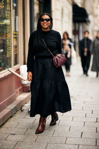 woman wearing black dress and boots