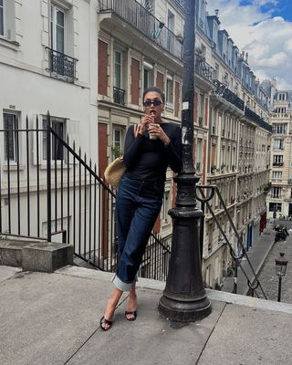 woman wearing cuffed denim outfit with black kitten mule heels