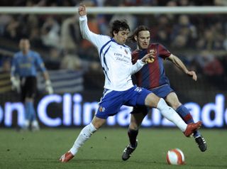Zaragoza's Diego Milito fights for the ball with his brother, Gabriel Milito, in a match against Barcelona in 2008.