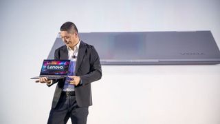Lenovo's senior vice president and general manager, Johnson Jia, on stage at CES 2020 holding a laptop